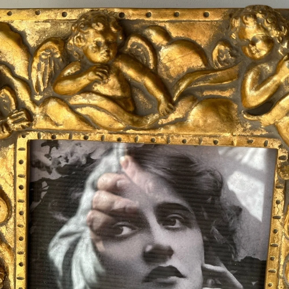 Large gilded Cherub Picture Frame holds 5”x7”. Rare